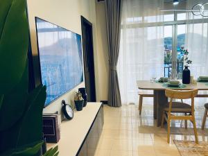 une salle à manger avec une table et une grande fenêtre dans l'établissement Wink City 4th Patong, à Patong Beach