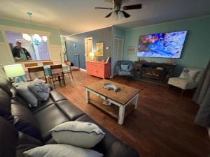 a living room with a couch and a table at Thats What Sea Said in Holden Beach