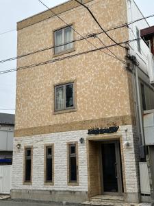 a brick building with two windows and a door at PAThouse台东Asakusa店 in Tokyo