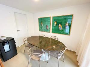 ein Esszimmer mit Tisch und Stühlen in der Unterkunft Térreo com 3 suítes beira-mar in São Miguel do Gostoso