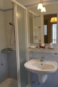 a bathroom with a sink and a shower with a mirror at Hotel Armando' s in Sulmona