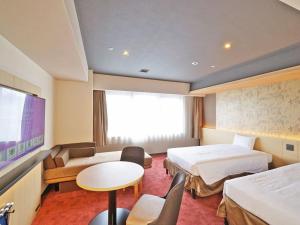 a hotel room with two beds and a tv at CHISUN PREMIUM Kyoto Kujo in Kyoto +106 photos
