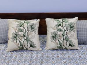 two pillows sitting on top of a bed at Divisha Homes-1BHK Luxury Apartment in South Delhi in New Delhi