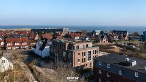 an aerial view of a city with houses and buildings at Brooklyn Bridge Suite List auf Sylt in List