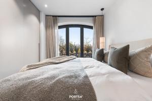 a bedroom with a bed and a large window at Brooklyn Bridge Suite List auf Sylt in List +20 photos