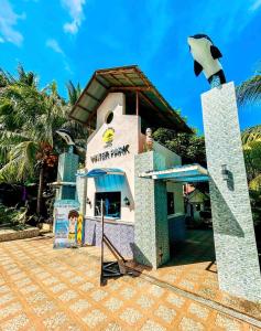 a restaurant with a building in front of it at Villa Paraiso Resort & Waterpark in Camiguin