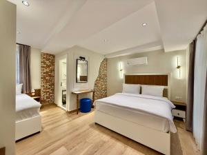 a hotel room with two beds and a mirror at Adria Inn in Antalya +116 photos