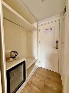 a small room with a kitchen with a microwave at Adria Inn in Antalya