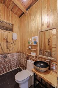 a wooden bathroom with a toilet and a sink at Khai Quynh Villa 3 - Venuestay in Khu Chi Lăng