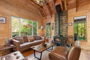 a living room with a couch and a fireplace at PNW River Cabin in Darrington +35 photos