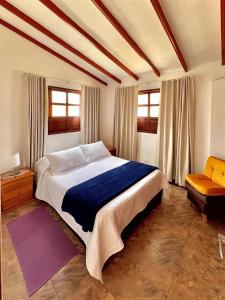 a bedroom with a large bed and a couch at Apartahotel Sacrosanta Trinidad in Villa de Leyva