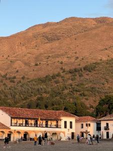 a large building with a mountain in the background at Apartahotel Sacrosanta Trinidad in Villa de Leyva +2 photos
