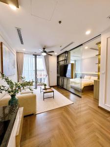 a large living room with a bed and a couch at Luxury Apartment in Vinhomes Times City - KaBi Home in Hanoi