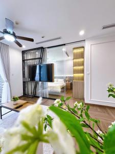 a living room with a tv and a couch at Luxury Apartment in Vinhomes Times City - KaBi Home in Hanoi