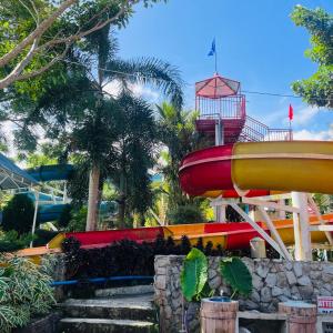 a group of different colored slides at a water park at Villa Paraiso Resort & Waterpark in Camiguin