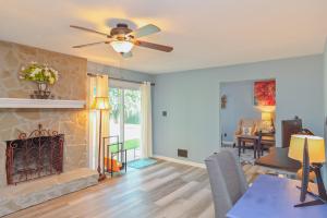 a living room with a fireplace and a ceiling fan at Master Vacation-Private pool Boutique Design House in Augusta