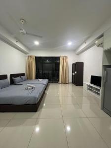 a bedroom with a bed and a flat screen tv at ISoHo i-City Studio 2 beds in Shah Alam