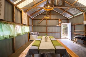 a room with a long table in a barn at Monratino The Orange Farmstay - Darjeeling in Takdāh +37 photos