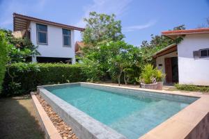 a swimming pool in the backyard of a house at Hermoso Hideaway in Ban Ang