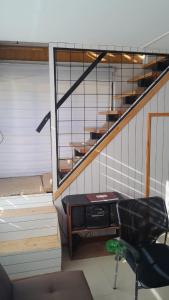 an office with a desk and stairs with a chair at Hostal Flor Austral in Chile Chico +2 photos