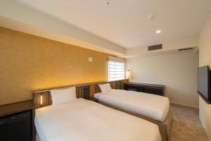Postel nebo postele na pokoji v ubytování Loisir Hotel Kyoto Toji