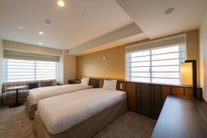 Postel nebo postele na pokoji v ubytování Loisir Hotel Kyoto Toji
