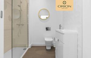 a bathroom with a shower and a toilet and a sink at The Kepties 4 - Luxurious Serviced Apartment by ORION SHORT STAYS in Arbroath