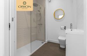 a bathroom with a shower and a toilet and a sign at The Kepties 4 - Luxurious Serviced Apartment by ORION SHORT STAYS in Arbroath
