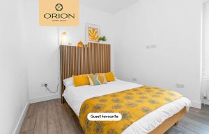 a bedroom with a bed with a yellow blanket at The Kepties 4 - Luxurious Serviced Apartment by ORION SHORT STAYS in Arbroath