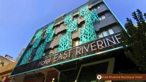 a building with a sign that reads hotel east riverine at East Riverine Boutique Hotel in Kuala Lumpur