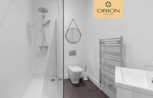 a bathroom with a shower and a toilet and a sink at The Kepties 3 - Luxurious Serviced Apartment by ORION SHORT STAYS in Arbroath