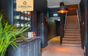 a hallway with a staircase and a potted plant at The Kepties 3 - Luxurious Serviced Apartment by ORION SHORT STAYS in Arbroath