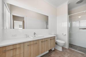 a white bathroom with a sink and a toilet at 29 Blanche Pd, Hindmarsh Island in Hindmarsh Island +14 photos