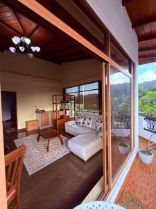 a living room with a bed and a balcony at Resident View Homestay in Kandy