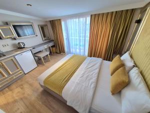 a hotel room with a large bed and a desk at Taksim La Marino Hotel in Istanbul