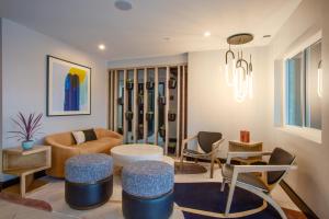 a living room with a couch and a table and chairs at voco Flagstaff by IHG in Flagstaff
