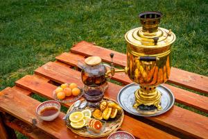 a table with two plates of food and a lantern at Bosogo Resort in Pervomayskoye +42 photos