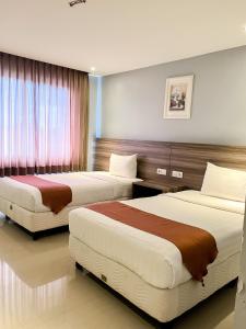 Postelja oz. postelje v sobi nastanitve SM Tower Hotel and Convention Berau
