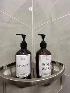 two bottles of soap on a metal shelf in a bathroom at Hidden Gem For Family 7Pax with Free WIFI in Cheras