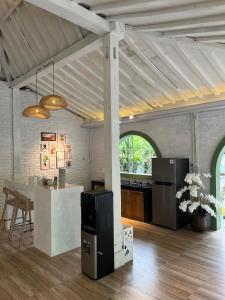 a kitchen with a counter and a table in a room at Sampai Villa nDalem Kaliurang in Cangkringan +1 photo
