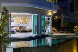 a house with a pool in front of it at Seaview 10 bedroom villa Bangtao beach area in Ban Thalat Choeng Thale