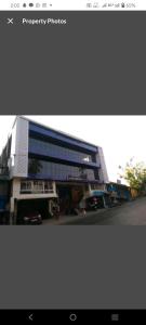 a large building with a street in front of it at Hotel Blue Bird Nest in Bumlitan