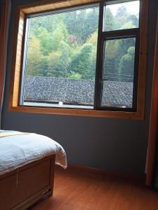 Park One B&B Zhangjiajie Forest Park Scenic Area Shop客房内的一张或多张床位