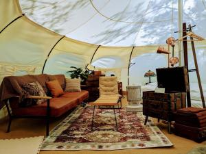 a living room with a couch and a tent at Roots inawashiro Lake Area in Sekiwaki