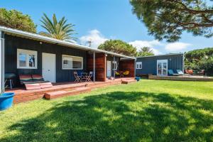a house with a deck and a yard at Apartamentos Zahora 37 in Zahora