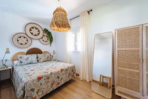 a bedroom with a bed and a mirror at Apartamentos Zahora 37 in Zahora +21 photos