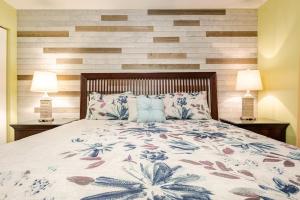 a bedroom with a large bed with two lamps at Seaside Serenity - Destin, FL in Destin +24 photos