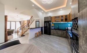 a large kitchen with a counter and a living room at Lala House Dalat in Da Lat
