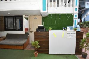 a room with a bed and a desk with plants at Hotel blue ocean studio rooms with kitchen baga beach in Calangute