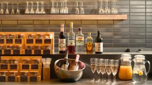 a bar with bottles of wine and glasses at WeBase KAMAKURA in Kamakura